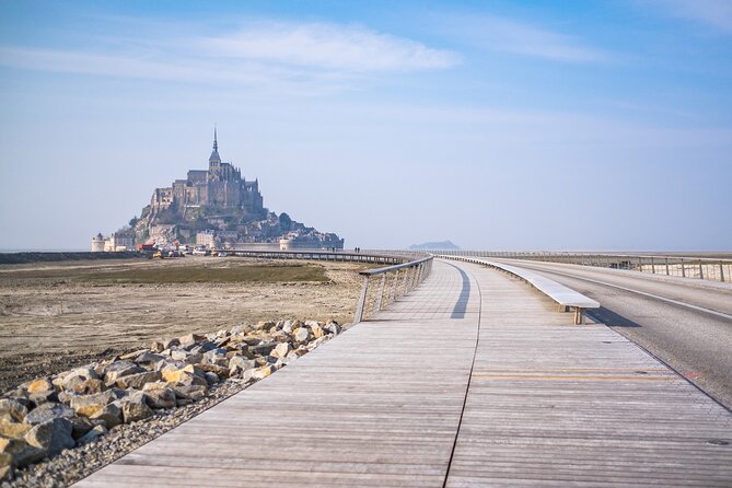 Mont Saint Michel Guided Day Trip with Hotel Pickup - Fortifications du Mont-Saint-Michel: narrow paths, pilgrims, and huge tide energy