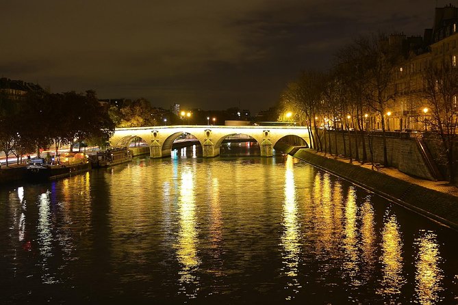 Paris By Night with Seine River Cruise and Roundtrip Luxury Transportation - Seine River cruise on Bateaux Parisiens: bridges, reflections, and motion