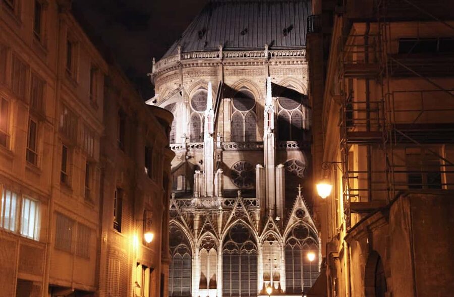 Paris: Ghosts, Legends & Mysteries Evening Walking Tour - Passing the Louvre: a familiar landmark used as a contrast tool