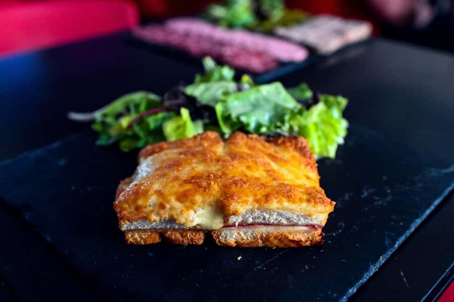 Paris: Le Marais District Food Tour with 10+ Tastings & Wine - Croque-monsieur and wine at a Jim Morrison favorite